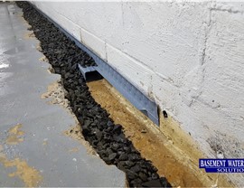 Low Profile Water Trench piping on footing