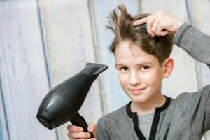 boy blow drying his hair