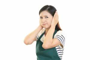 woman holding ears