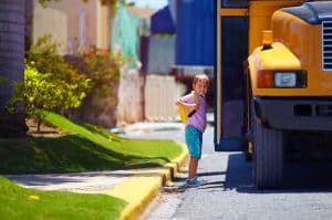 kid getting on a school bus