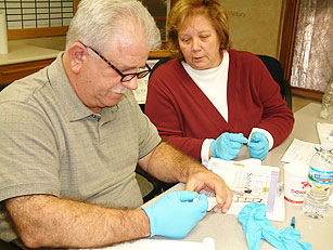 two adults conducting lead testing