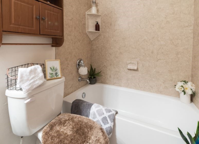 remodeled bathtub with beige textured walls