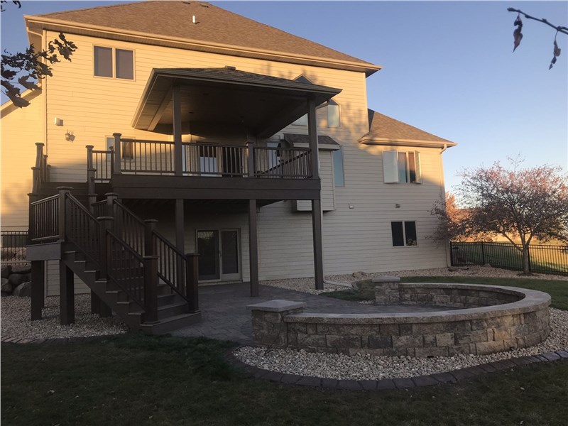 2 story home with a deck and patio area